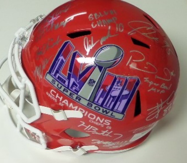 This NM/MT red full size helmet from Riddell features a KC logo on one side, and a Super Bowl LVIII logo on the other.  It comes hand-signed in bright silver by 9 stars of this now-dominant franchise, including Andy Reid, Patrick Mahomes, Travis Kelce, Isiah Pacheco, Rashee Rice,Mekole Hardman,,Chris Jones, MVS, Humphrey, & Butker  Check out our attached photo to see all included, and retail on this gorgeous display piece is thousands!