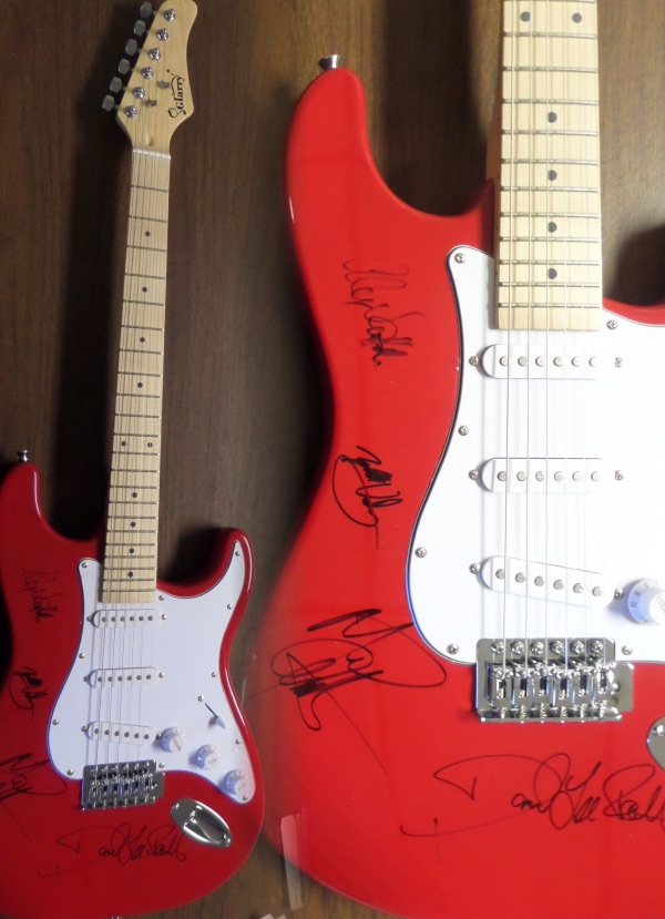 This mint, all bright red full-sized electric guitar is neat-looking with unique styling and comes hand signed by all 4 bandmates including lead guitarist and now deceased star Eddie Van Halen,Alex,Michael, and David Lee Roth!   It comes IN PERSON obtained, grades as good as it gets on the mint guitar, and shows off well from 30+ feet away. Great musical investment in the well known Rock N Roll group, and is complete with Lee's own lifetime guarantee included and original carry bag,etc.. WOW!