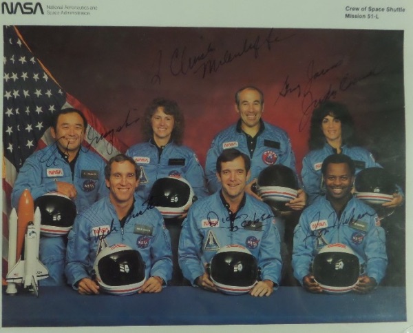 This amazing collector's item is a full 8x10 color NASA photo of all seven members of the "Challenger" mission, all of whom died tragically in the take off explosion.  It is hand-signed in black sharpie by all seven, including McAuliffe, Jarvis, McNain, Onizuka, Resnik, Smith and Scabee and this piece values well into the thousands!