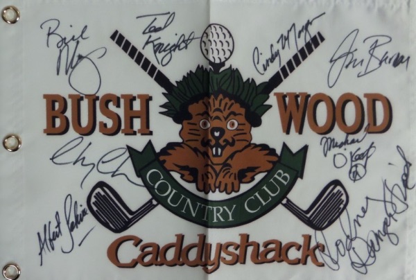 This white canvas "Bushwood Country Club" pin flag from the movie Caddyshack has been black felt marker signed by no less than EIGHT cast members, including Chevy Chase, Bill Murray, Michael O'Keefe, Cindy Morgan, and the late Rodney Dangerfield.  Also included are Ted Knight, Albert Salmi, and John Barmon Jr--three names you pretty much never see included.  All signatures grade 8's or better on this piece that is a must have for fans of the classic comedy, and values into the hundreds.