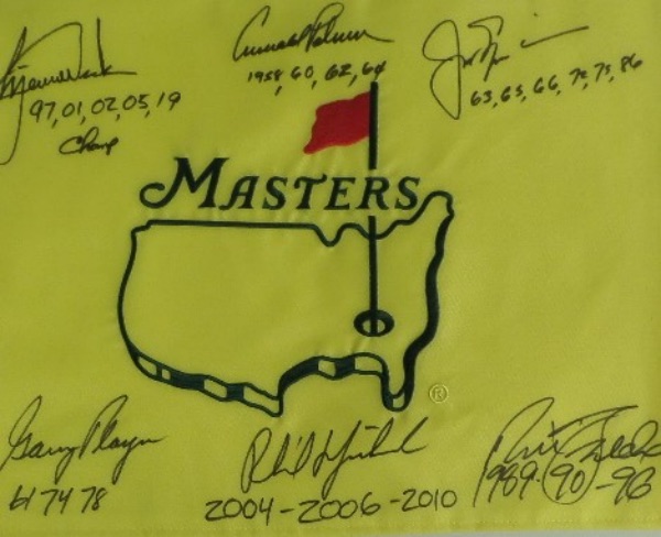 This MINT condition, authentic style yellow Masters pin flag features the Masters logo embroidered, and comes hand-signed all around in black sharpie by no less than SIX PGA greats who have won the famed Augusta major at least three times!  Included are Jack Nicklaus, Arnold Palmer, Gary Player, Tiger Woods, Nick Faldo, and Phil Mickelson, and each golfer has added the years that he won the tournament as an inscription.  NO golf collection would be complete without this crown jewel, valued into the low thousands!