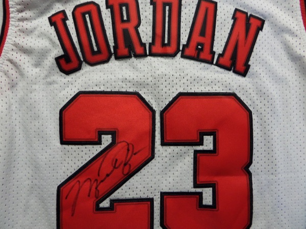 This mint, well designed Chicago home white is trimmed in team colors, has sewn on everything as well as name on back, and comes back number signed by the NBA Phenom in bold black marker. Grade is a bold, large 10 all over, and value is thousands on the very sought after Legend.