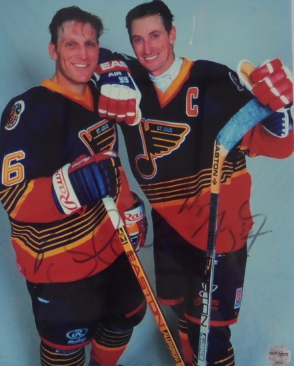 This outstanding NHL item is a full color 8x10 photo of NHL all time greats Brett Hull and Wayne Gretzky posing together in 1996 as members of the St. Louis Blues.  It is hand-signed by BOTH in black felt marker, each grading a lighter but legible 5-6, and the photo includes a COA and hologram from GCP Sports for authenticity purposes.  Valued into the mid/high hundreds!