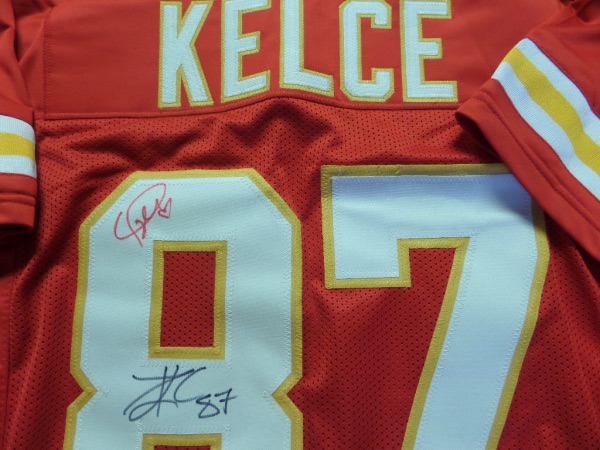 This red size L Kansas City Chiefs custom football jersey is in NM condition, and has everything sewn.  It is back number-signed in black by All Pro TE Travis Kelce, grading an overall 8, with 87, and oh yeah, it's also signed in RED by his girlfriend, international music star, Taylor Swift!  Is there a hotter item right now on the memorabilia circuit?