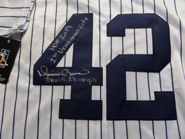 This new with tags pinstripe jersey is a Nike dream, has his #42 sewn on back, and comes silver paint pen perfectly signed by the 1st ballot HOF pitcher. It grades a clean bold 10 all over, shows off well from 20 feet away, and comes with Lee's added approval and our famous, NO reserve opening bid pricing.