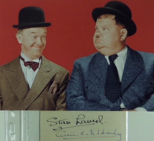 This vintage cut of white paper measures right around 1.75x4.25 in size, and comes hand-signed by the legendary comedy duo of Laurel & Hardy!  Hardy's signature is in blue ink, grading about a 6, and Laurel's is in black felt marker, grading a strong 8, and the cut includes a color photo for matting and framing to make your own display.  With both men long gone, retail here is mid/high hundreds!