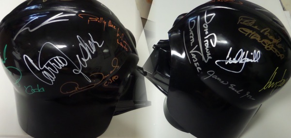 This nice-looking Darth Vader helmet is in EX/EX+ condition, and can slip over your head if you are in the mood to be evil! It is black and comes signed in various vibrant colors by 10 stars from the popular Star Wars movies.  The sig's are 7's-9's overall, and included are Lucas, Oz, B.D. Williams, Fisher (dec), Daniels, Prowse (dec), Mayhew (dec), Jones (dec), Ford and Hamill.  A truly unique and stunningly colorful display item with a retail value WELL into the thousands!