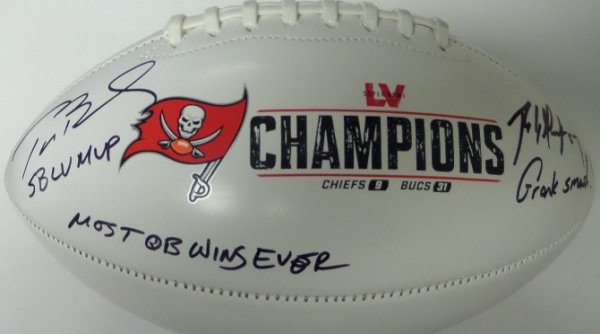 This Tampa Bay Buccaneers Super Bowl LV Champions logo triple white panel football is in NM/MT condition, and comes hand-signed in black sharpie by this future HOF QB/TE tandem.  Signatures grade 9's each, with Brady adding SB LV MVP and MOST QB WINS EVER, and Gronk adding Gronk Smash! and 87!  Awesome piece from a memorable year, and retail is high hundreds!