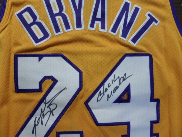 This yellow size 50 Kobe Bryant #24 Lakers '08/09 throwback jersey from Mitchell & Ness is like new, and comes trimmed in purple and white, with everything sewn.  It is hand-signed in his full name on the back number in black sharpie by the all time great himself, with a cool Black Mamba inscription added, and with his 2020 death, this amazing looking jersey is valued well into the low thousands!