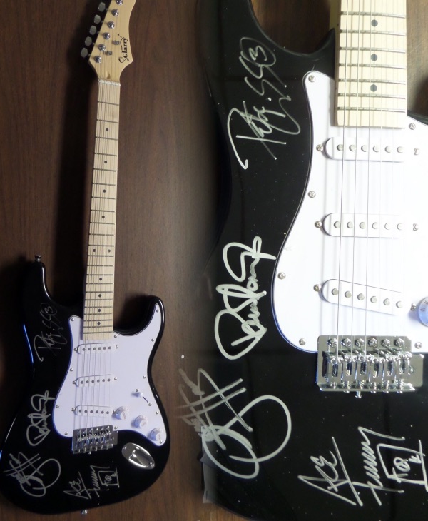 This black "statocaster style" guitar is in store bought condition, and comes brilliantly body signed in silver paint pen by all four members of this iconic '70's hard rock hit machine band!  Included are Gene Simmons, Peter Criss, Paul Stanley and Ace Frehley, with the signatures grading legible 8's or better, and this guitar will show off spectacularly in any rock music collection!