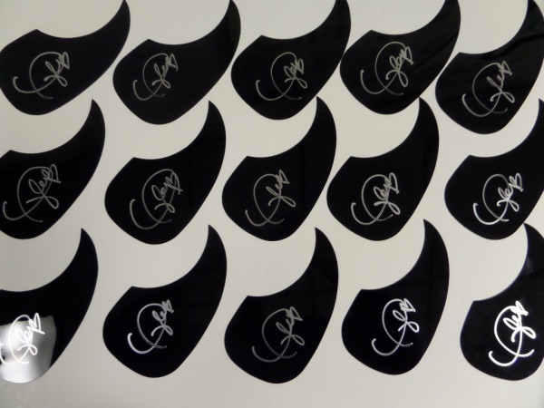 When it comes to shear retail potential, you'd be hard-pressed to find a better opportunity than this group of FIFTEEN black acoustic guitar pick guards, each hand-signed in silver by pop superstar, Taylor Swift!  So, what you're telling me is that you can make FIFTEEN signed guitars from this lot?  You sure can!  And just think about the wad in your pocket when you're done selling those babies off!!!