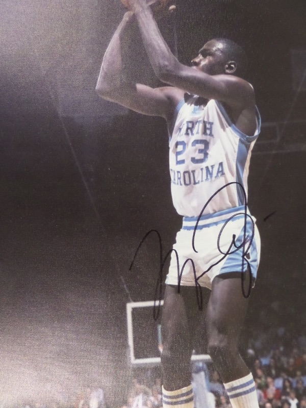 This full color 19x23 litho print is done on actual canvas, and features many different images of Michael Jordan taking the winning shot of the 1982 NCAA Tournament with North Carolina.  It is hand-signed in black sharpie by the legendary cager himself, grading about a 7.5-8, and will frame and display beautifully in any basketball collection.  Valued into the high hundreds!