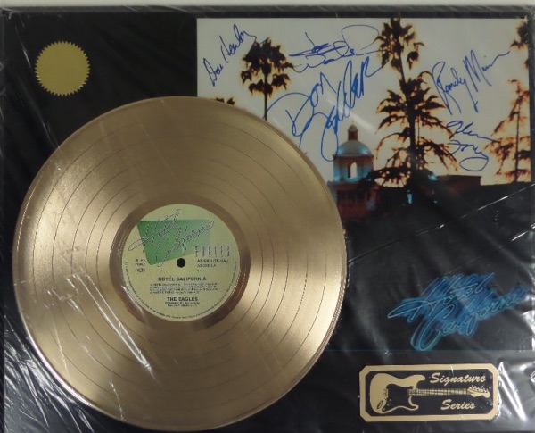 This 16x20 NM plaque display features a "gold" Hotel California record and a full color album print that features the facsimile signatures all five band members!  Included are Don Henley, Glenn Frey, Randy Meisner, Don Felder and Joe Walsh, and the piece is certified by "Gold Record Outlet."  An awesome display, ideal for any music collection!