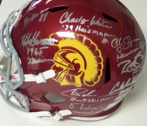 This full size USC Trojans team logo maroon replica football helmet from Schutt is still in NM/MT condition, and comes hand-signed in silver by 8 men who have won the Heisman as a member of the school's football program.  All of the signatures reside on the same side for display, all grading 8's or better with their Heisman years added, and included are OJ, Garrett, Palmer, Bush, Leinart, Allen, White, and even 2022 Heisma winner, Caleb Williams.  AWESOME piece of USC memorabilia here, and retail is low thousands!