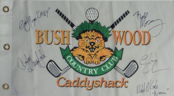 This white "Bushwood Country Club" pin flag from the movie Caddyshack has been black marker signed by 5 cast members, including Chevy Chase, Bill Murray, Michael O'Keefe, Cindy Morgan, and the late Rodney Dangerfield.  All signatures grade 9's or better on this piece that is a must have for fans of the classic comedy, and values into the high hundreds and nice! A few even included their character names!