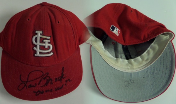 This well worn cap is circa 1973, has his #20 written under the brim, and comes hand signed and acknowledged by the late HOF'er. It is his size 7 1/8, tagged right by New Era, and has "Game Used" written by Brock himself for assurance. 