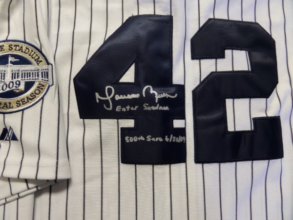 This new, tagged mint jersey is a 2009 Inaugural Season home white pinstripe with patch, and sewn on team logo, as well as the HOF pitchers #42 on the back. It comes not only hand signed in clean bold silver paint pen, but grades a 10 all over AND has written added stats from Rivera too. Great buy, easy HOF investment, and valued upwards of a grand. 