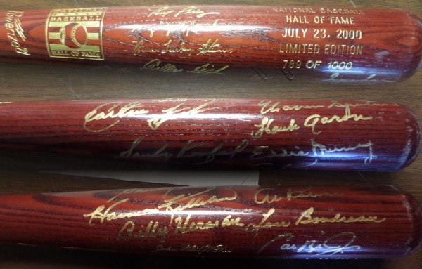 This rich brown colored Louisville Slugger baseball bat is in EX/MT shape overall, with the 2000 HOF Induction and Inductees signatures barrel engraved.  It is hand-signed in GOLD by 10, including Lou Boudreau, Billy Herman, Harmon Killebrew, Al Kaline, Sandy Koufax, Eddie Murray, Hank, Aaron, Warren Spahn, Carlton Fisk and Cal Ripken Jr!  AWESOME bat, and, with 6 deceased, retail is HIGH!!!