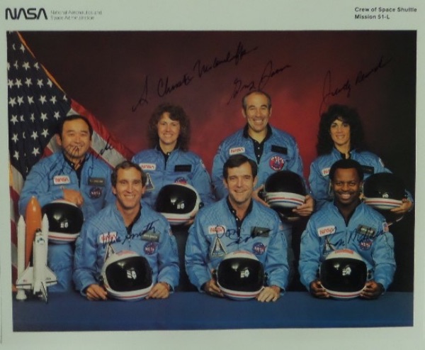 This amazing collector's item is a full 8x10 color NASA photo of all seven members of the "Challenger" mission, all of whom died tragically in the 1986 take off explosion.  It is hand-signed in dark-blue flair pen by all seven, including McAuliffe, Jarvis, McNain, Onizuka, Resnik, Smith and Scabee and this piece values well into the thousands!