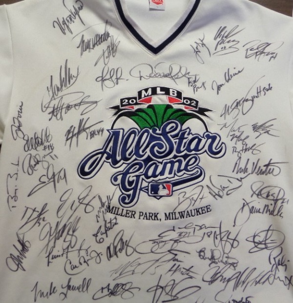 This amazing and one of a kind jersey looks to have been custom-made, and is a size L, with a HUGE 2002 MLB All Star Game logo on the front.  It is hand-signed all around this logo in black sharpie by well over 50 All Star players and coaches from '02, including HOF'ers Derek Jeter, Cal Ripken, Ken Griffey Jr, John Smoltz, Tom Glavine, Joe Torre, and Paul Molitor, superstars and All Stars like Curt Schilling, Johnny Damon, Barry Bonds, and Sammy Sosa, and Alex Rodriguez, and so many more.  Check out our photo and cross-reference with the rosters.  Fantastic!!!