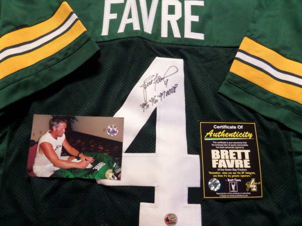 This mint Green Bay road green is trimmed in team gold and whiite and has sewn on everything as well as name on back. It comes back #4 signed by the HOF Great in bold black sharpie, grades a clean bold 10 all over, and has a fewf career stats written by Favre himself. OK'd by Lee for certainty, and value is upper hundreds, It comes with TONS of certs, pics and holograms from Favre's own company, and lists his THREE MVP NFL seasons on the back. Wow!!