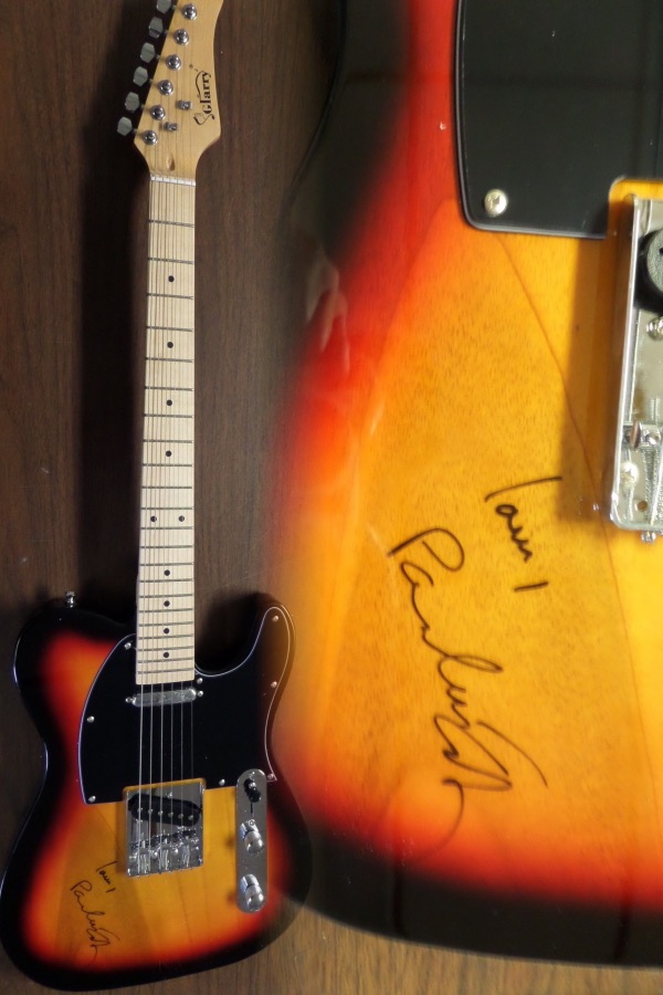 This gorgeous mint electric sunburst telecaster style guitar comes with the original box, pick ups, bag, straps,etc. and comes signed by the best singer/songwriter of all time in black. SUPERB autograph and shows off wonderfully. Guaranteed authentic and get it now because Paul is a tough autograph and not getting any younger! He even included "LOVEt" above his tough-to-get signature!