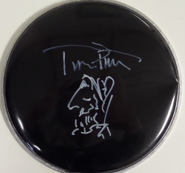 This 10" diameter black drum head has no manufacturer's markings on it, and is in EX/MT condition overall.  It is hand-signed in WHITE paint pen by the HOF rocker himself, and has a self-portrait included--please refer to our attached photo.  With Petty's death now just short of a decade ago, retail is high hundreds!