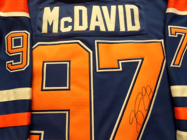 This mint dark blue authentic Edmonton Oilers jersey has embroidered everything and is trimmed in white and orange and GORGEOUS. It comes signed on the back numbers wonderfully by this top draft pick and megastar and best player in the game with his #97 included. Retail is already into the low thousands from this stud and rising as they could win it all this year as I am typing this in!!