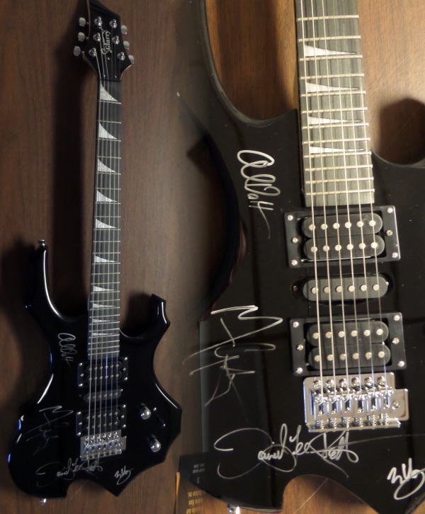 This mint and STUNNING all black full-sized electric guitar is neat-looking with unique styling and comes hand signed by all 4 bandmates including lead guitarist and now deceased star Eddie Van Halen,Alex,Michael, and David Lee Roth!   It comes IN PERSON obtained, grades as good as it gets on the mint guitar, and shows off well from 30+ feet away. Great musical investment in the well known Rock N Roll group, and is complete with Lee's own lifetime guarantee included and original carry bag,etc.. WOW!