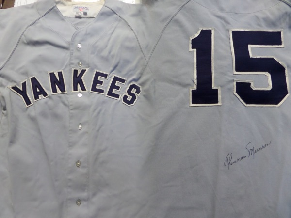 Wow, this vintage Aladen made jersey is a custom size 42 and a buttonup in superb condition! Obviously made in the 70's with "YANKEES" on the front and Thurman's #15 on the back!  All sewn on and the back comes signed below the numbers in black by this deceased legend! Gorgeous signature and retails well into the thousands easily due to scarcity. 