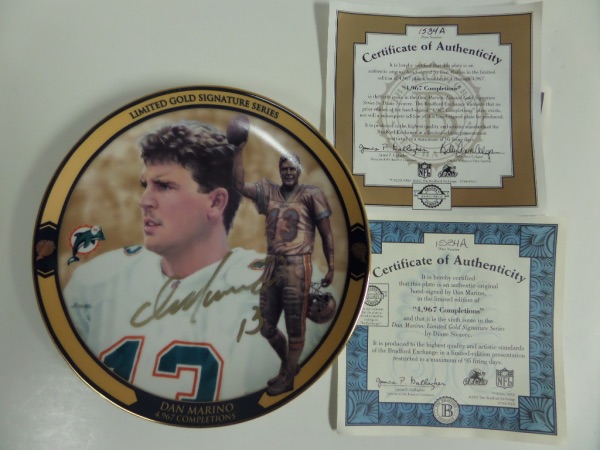 This 8" diameter Limited Gold Signature Series Dan Marino 4967 Completions collector's plate is in pristine condition, and numbered 1534A from a limited edition of 4967!  It comes hand-signed in GOLD by the all time great QB himself, and is furnished with two COA's from Bradford Exchange--one for the limited edition, and the other for the autograph!!!  AWESOME Marino/Dolphins item, and valued into the mid/high hundreds!