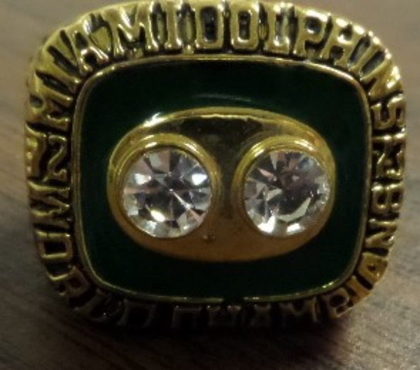 This must have Item is a real ring, a superbly done ring, and in real celestrium, with a HUGE diamond like stones, CZ's evident on the top. It is the "LARRY CSONKA" ring from the 1973 Dolphins Championship, has his last name engraved on one shank,  and their winning Super Bowl score on the other. This is the ring they selected, an EXACT version of the real one, and quite literally, THE VERY FIRST ONE WE'VE EVER HAD UP FOR AUCTION!!!! This super ring is valued HIGH, and It is an impossible ring to find, a super Miami wear around or display piece.