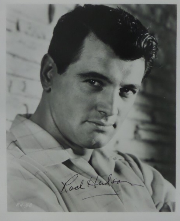 This black and white photo is a close up image of 1950's-60's heartthrob actor, Rock Hudson.  It is hand-signed in black ink by the "Pillow Talk" and "Giant" star himself, grading a legible 7.5, and a COA is affixed to the back from former Cinema Showcase host/producer, Jim Whaley, for authenticity purposes.  With Hudson's tragic early '80's death from A.I.D.S., this photo is valued into the low thousands!