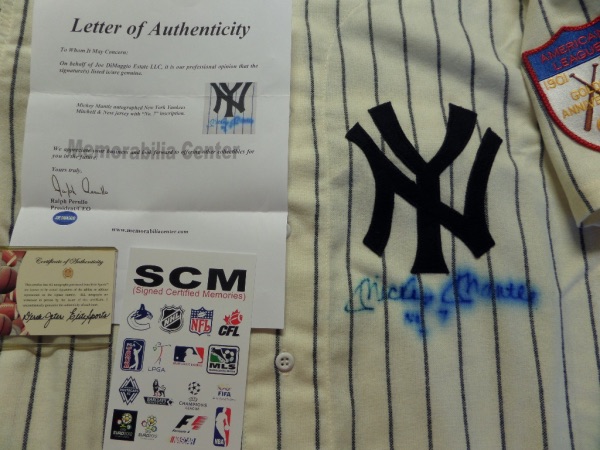 This Cooperstown Coll. throwback Mantle flannel has his #7 on the back.  It is in super shape and comes signed on the front under the NY logo by the Mick in blue!  As you can see from the picture, it does have bleeding on it and his "NO.7" he included!  Still ideal for framing and display and comes with hologram/COA's from ELITE Sports, Joe Dimaggio Estate, & SCM for authenticity. Wow!