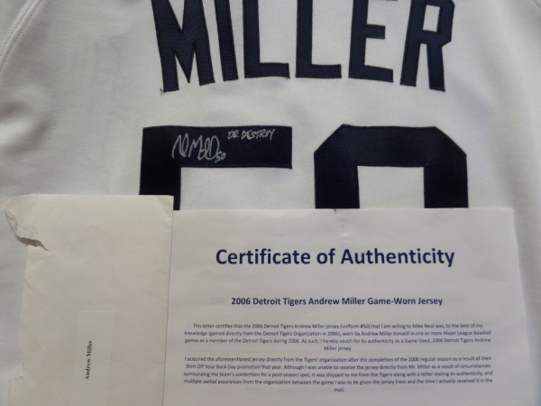 This very large home white Detroit Tigers #50 Miller jersey has all the proper tagging at the bottom from Majestic, and comes back number-signed by the 2 time All Star reliever himself.  Signature grades a legible 7.5, complete with his Dr Destroy nickname added, and the jersey comes with documentation from the original collector, who acquired the jersey directly from the Tigers in 2006, Miller's rookie season, and, incidentally, the year the Tigers took home the AL flag, so this piece is a MUST for the serious Detroit sports fan!