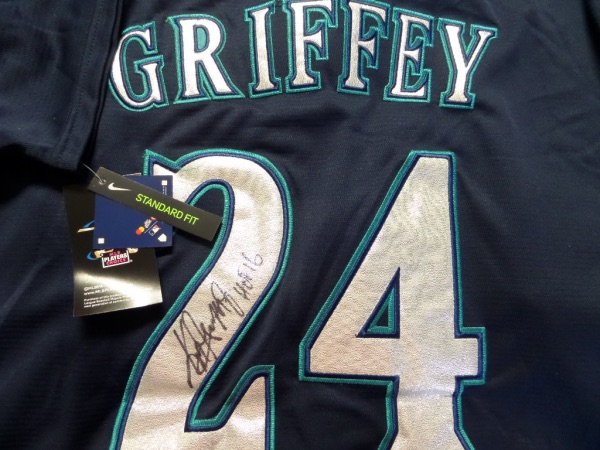 This mint authentic dark blue Mariners jersey comes signed by this legendary HOF centerfielder.  Gorgeous autograph with HOF 16 included and the jersey BEGS to be framed and shown off! Retails in the high hundreds from the Kid and guaranteed authentic.