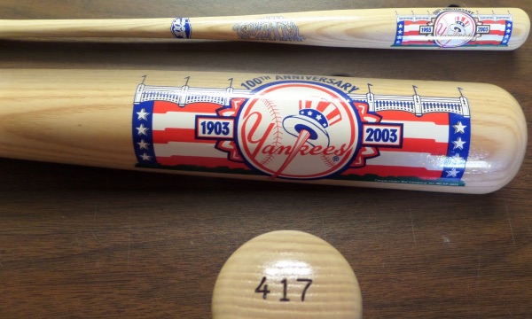 This NM blonde bat from The Cooperstown Bat Company is still in NM condition, and is numbered 417 on the knob.  It features colorful red white and blue artwork on the barrel, showing the Yanks' team logo, an image of the stadium's famed facade, and 100th Anniversary.  A MUST for your Yankees collection, and a fantastic display item!