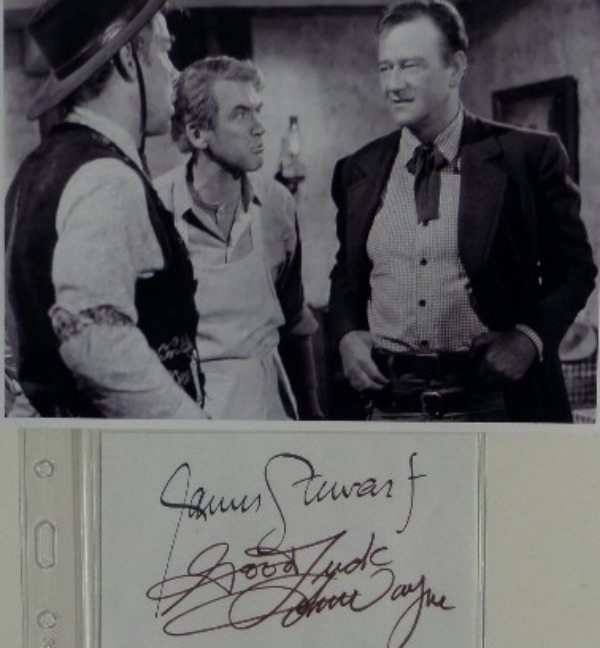 This index card sized cut of white paper is in EX/MT shape, and comes hand-signed by two of the most iconic actors in film history.  Included in brown felt marker is John Wayne, as well as James Stewart in black, and the cut is accompanied by a black and white "Man Who Shot Liberty Valence" photo for display.  With both legends long gone, retail is high hundreds!