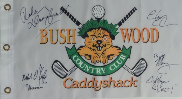 This white "Bushwood Country Club" pin flag from the movie Caddyshack has been black marker signed by 5 cast members, including Chevy Chase, Bill Murray, Michael O'Keefe, Cindy Morgan, and the late Rodney Dangerfield.  All signatures grade 9's or better on this piece that is a must have for fans of the classic comedy, and values into the high hundreds and nice! A few even included their character names!