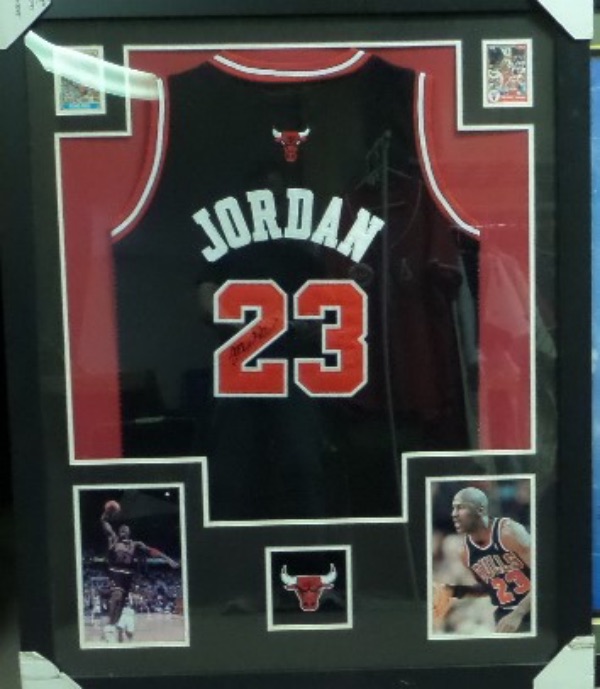 This HUGE 36"x45" piece comes professionally framed and ready to display.  It will be super expensive to ship, so much cheaper if local buyer can pick up.  It contains a signed Jordan authentic-style Bulls jersey and comes with a COA from Capital City Collectibles on the back.  The signature is not a normal Jordan and quickly-done in black and the frame also includes repro. cards and action photo's. A stunner with super high retail value. 
