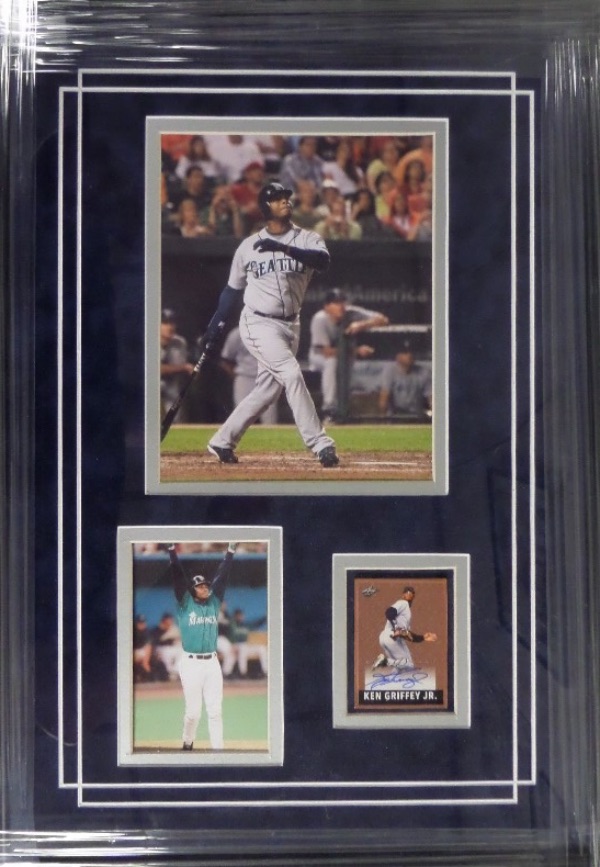 This professionally-crafted 18x25 framed and double matted display features photos and a 2022 Leaf Decadence Ken Griffey Jr. certified autographed baseball card.  It is MINT, ready for display, and the card alone retails into the high hundreds without this impressive presentation!