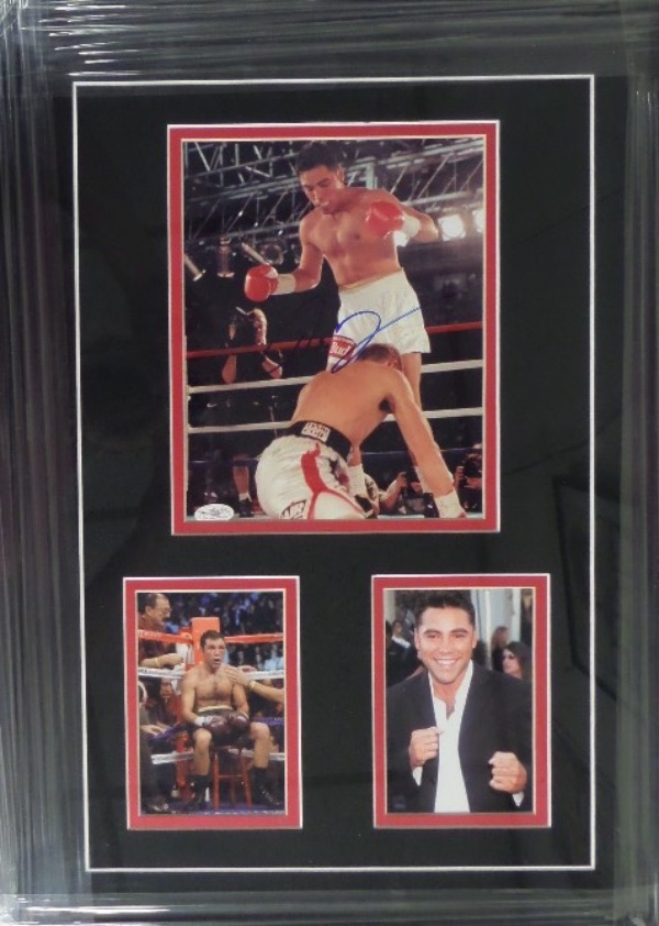 This 18x25 professionally-framed and double matted display is a real looker, featuring color photos, the largest of which is an action fight photo that is blue sharpie-signed by the HOF fighter himself.  The piece is affixed with a JSA sticker (E09666) for authenticity purposes, and retail is high hundreds!
