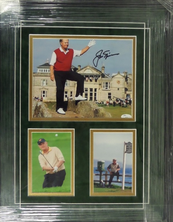 This beautiful 18x23 professionally-framed display is done in Masters gold and green, and features a color photo of Jack standing and waving to the crowd at the Ancient Golf Club in St. Andrews.  It is hand-signed in black sharpie by the greatest golfer EVER, and comes JSA certified (J63310) for authenticity purposes.  Ready for display and valued into the low thousands!