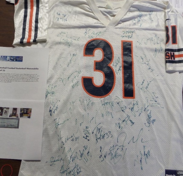 This white XL Rahan Salaam #31 Chicago Bears jersey is still in EX shape, and comes front-signed in blue felt tip marker by more than 25 members of the '97 Bears.  Included are notables like Ricky Proehl, Todd Burger, Chris Penn, Sean Harris, Tony Peterson, Van Hiles, John Allred, Bobby Engram, Casey Wiegmann, Todd Sauerbrun, Marty Carter, John Mangum, Terry Cousin, and many more.  Those are some of the names I can make out.  See out attached photo to see if you can get some that I didn't!  A copy of the original MEARS group LOA is included, which actually shows this jersey in the picture!