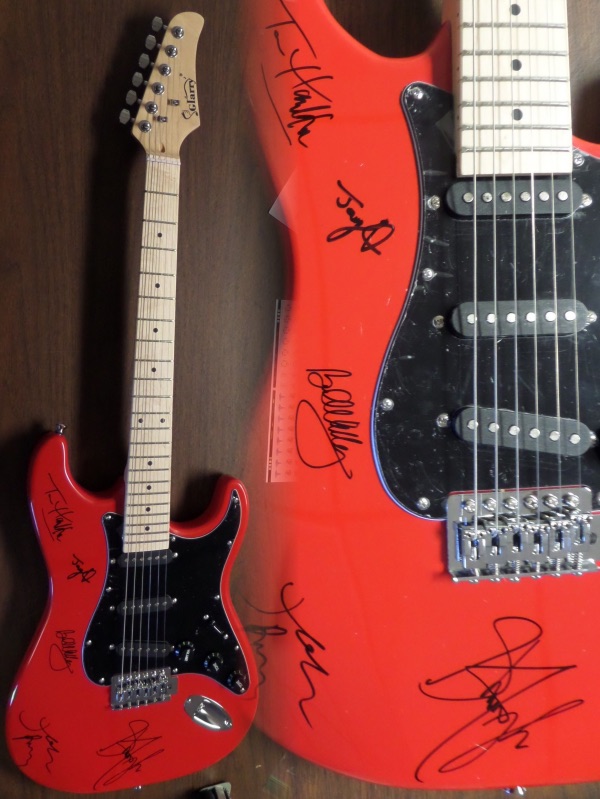 This mint GORGEOUS red electric guitar comes body signed by all five members of this iconic hard rock band!  Included are Hamilton, Kramer, Perry, Tyler and Whitford, all in bold black sharpies, and this baby will show off in Hard Rock Cafe style!  Valued into the low thousands+++ and comes with original carry case, bag, pick ups etc.. WOW Guaranteed authentic. 