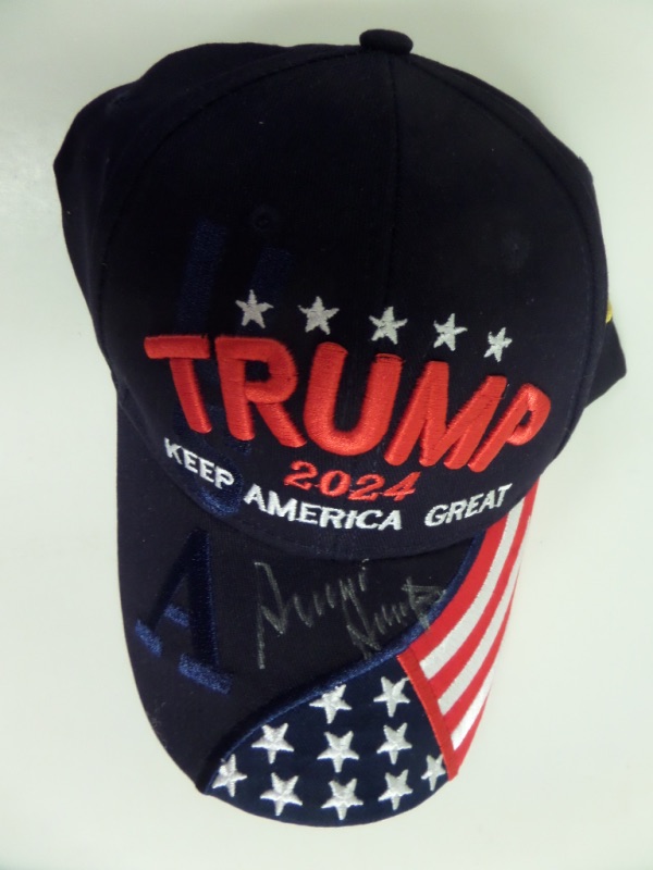 This mostly black Trump 2024 Keep America Great cap is in NM condition, and comes hand-signed on the brim in silver sharpie by the President of the United States!  The signature is a legible 7, and this beautiful cap can easily retail into the low thousands!