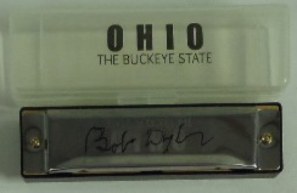 This silver OHIO: The Buckeye State harmonica is in EX/MT condition, and comes signed on the top superbly in black sharpie by this award-winning singer and songwriter.  The great display item is ideal for the music collector.  Nice and rare.